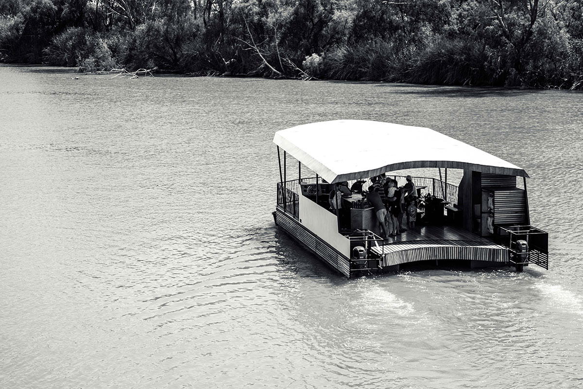 natura barge cruising along the river